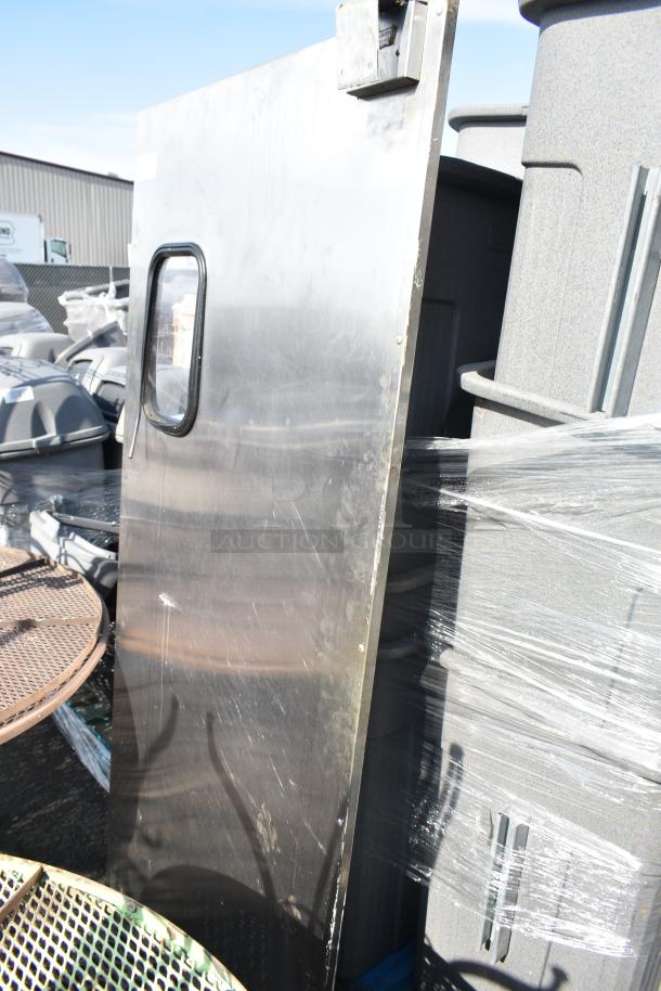 Eliason stainless steel swinging kitchen door with window, visible wear, includes hardware, ideal for high-traffic areas.