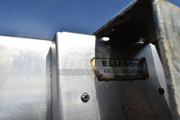 Eliason stainless steel swinging kitchen door with visible label, includes hardware, minor wear, durable construction.