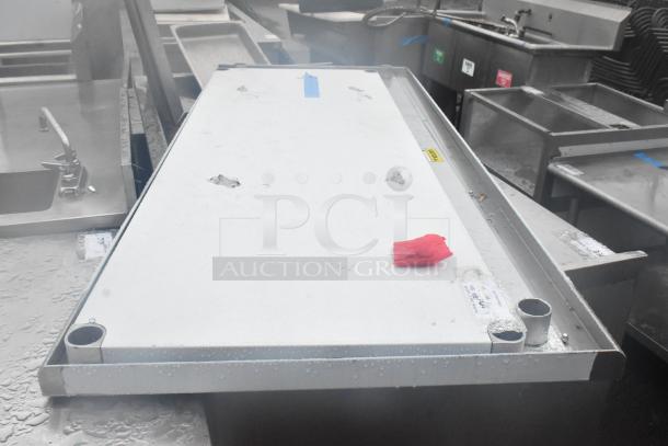 Brand new scratched tabletop and under shelf with visible dings and protective wrapping on corners.