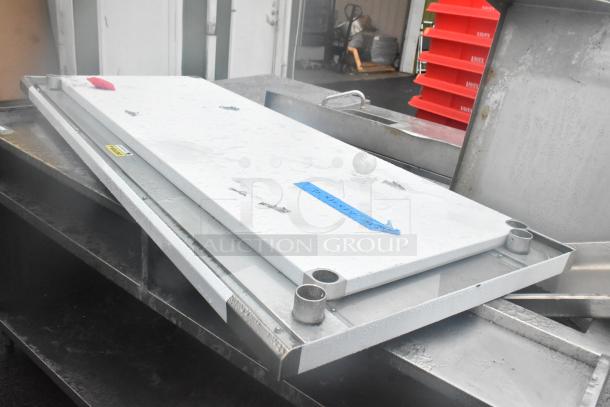 Brand new tabletop with under shelf showing minor scratches and dents. White surface, metal edges, visible blue and yellow tags.