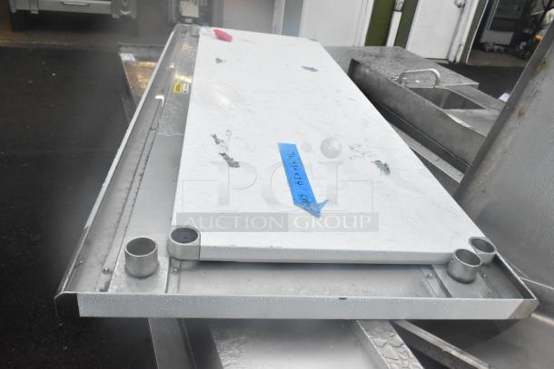 New tabletop and under shelf with visible scratches and dents. White surface with blue tape mark "24x60x52."