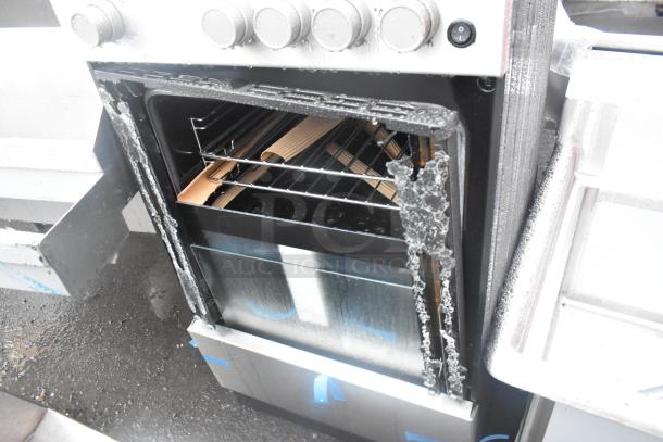 4 burner range with visible oven door damage, featuring control knobs and interior racks. Oven door shows wear and tear.