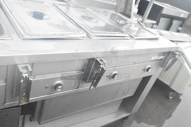 Dinex DHF6 commercial steam table with over and under shelves, 208 volts. Features stainless steel construction.