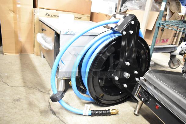 BRAND NEW Regency powder-coated steel air/water hose reel with hose, shows minor scratches. Robust build and efficient design.