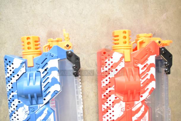 Two Nerf Rival toy guns, one blue and one red, with distinctive striped designs, in excellent condition.