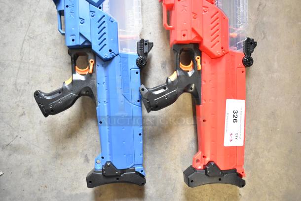 Two Nerf Rival toy guns, one blue and one red, with black handles and orange accents; good condition, labeled "326 QTY x2".