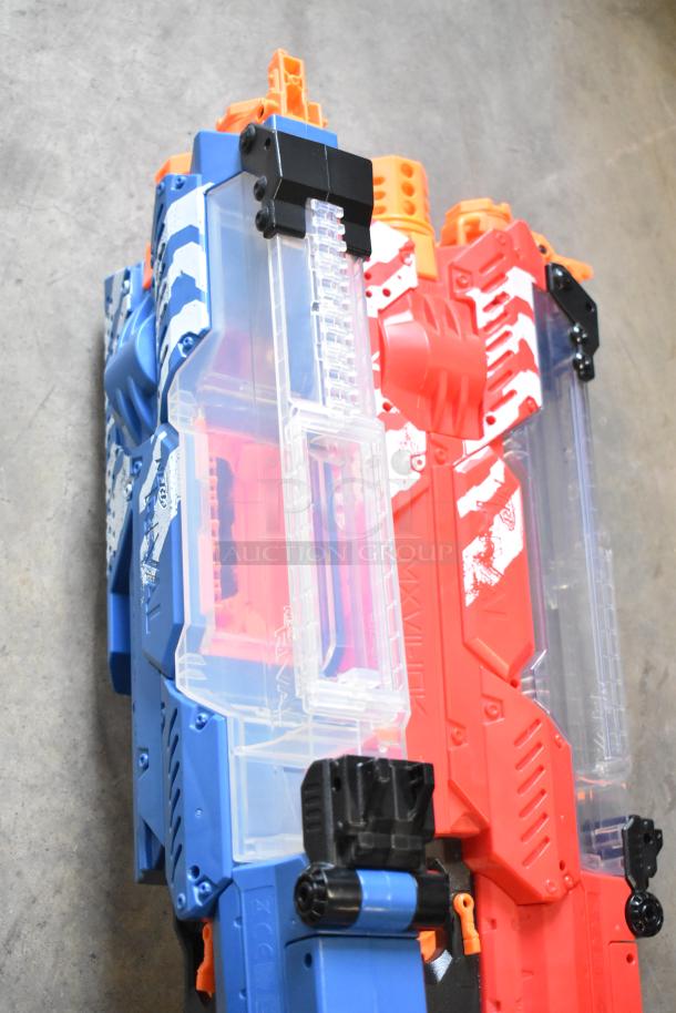 Two Nerf Rival toy guns in blue and red, featuring clear chambers, vibrant color schemes, and visible brand markings.