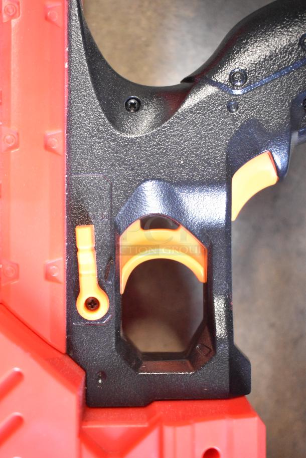 Close-up of a Nerf Rival toy gun showing black and orange trigger area, in good condition, highlighting textured grip.