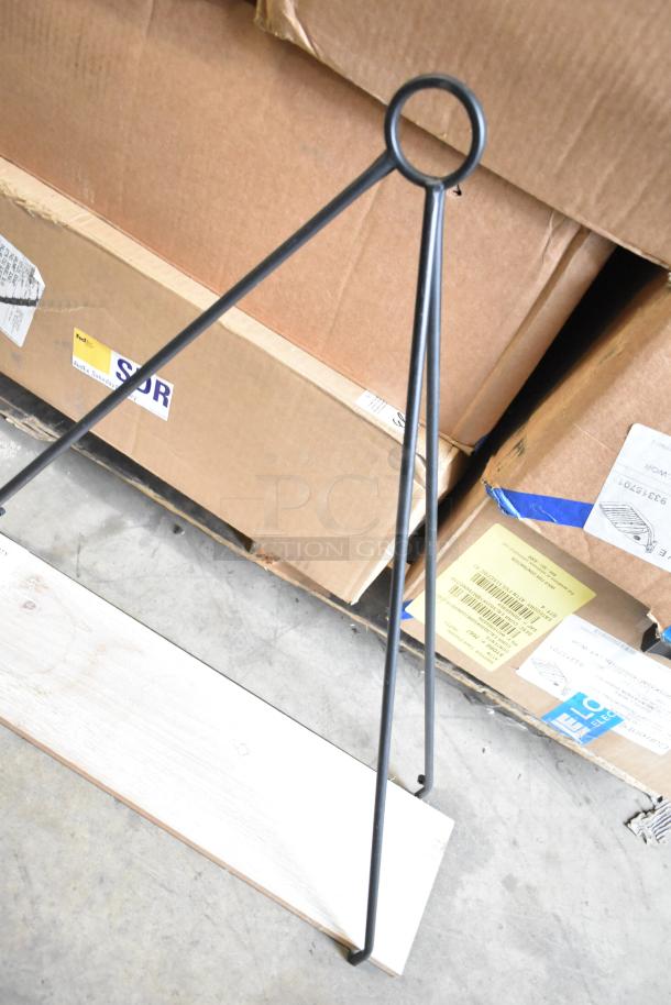 Black metal stand with triangular structure, loop top, and wooden base. New condition, ideal for displays or signage.