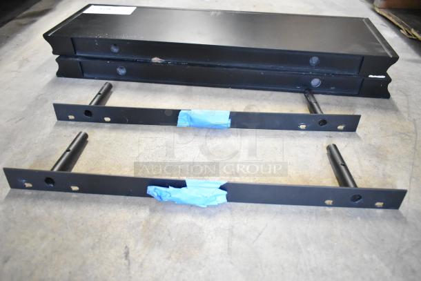 Two black wall-mounted shelves, partially assembled, with mounting brackets. Slight wear visible. Includes two sets for auction.
