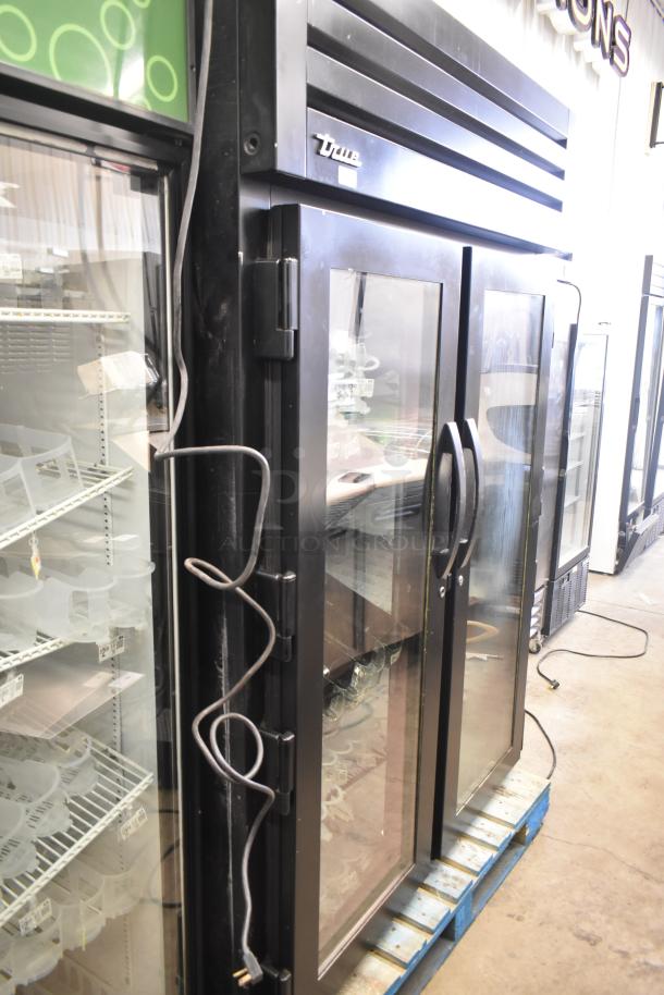 2017 True STG2RPTVLD-2G-2S-HC commercial 2-door reach-in cooler with locked right door, black frame, glass panels. 115V, 1-phase.
