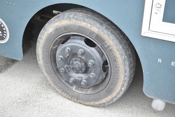 Freightliner Ludicrous food truck wheel, featuring a Blackhawk tire, part of a fully equipped mobile kitchen.