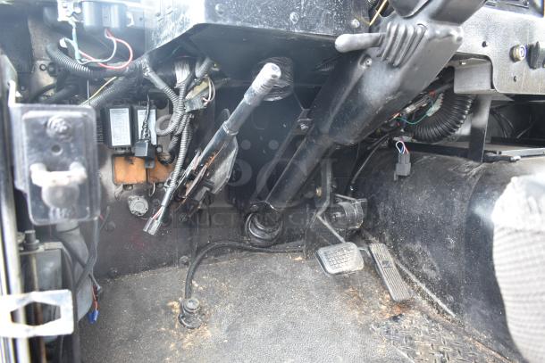 Interior view of the Freightliner Ludicrous Food Truck cab showing wiring, pedals, and controls.