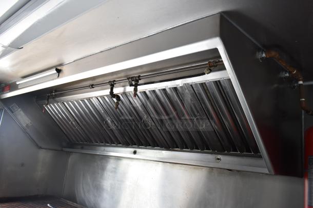 2002 Freightliner food truck grease hood with ventilation system, featuring propane hookup and visible pipe connections.
