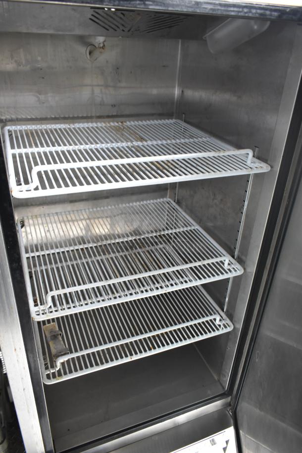 Interior of a food truck's refrigeration unit with wire racks, part of a 2002 Freightliner Ludicrous Food Truck.