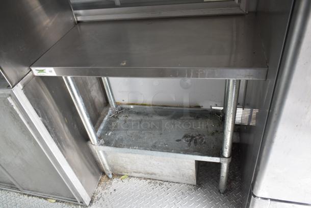 2002 Freightliner Ludicrous food truck interior; stainless steel prep area, propane hookup, grease hood visible.