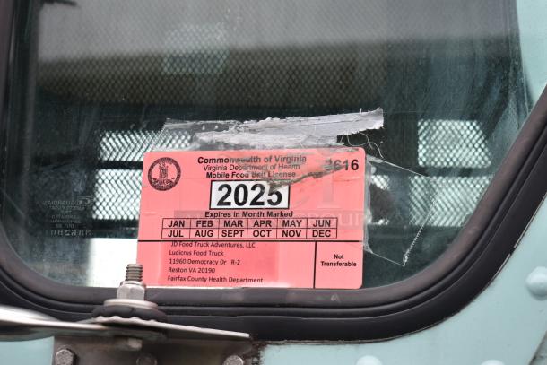 2002 Freightliner Ludicrous food truck license for Virginia mobile food unit, valid until 2025, visible on window.