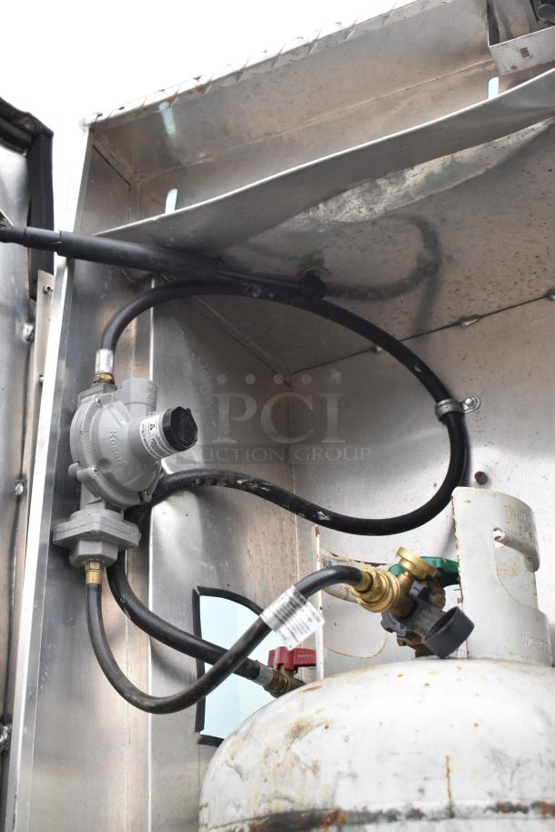 Propane hookup for a 2002 Freightliner Ludicrous Food Truck with visible hoses and connections, ensuring functional gas flow.