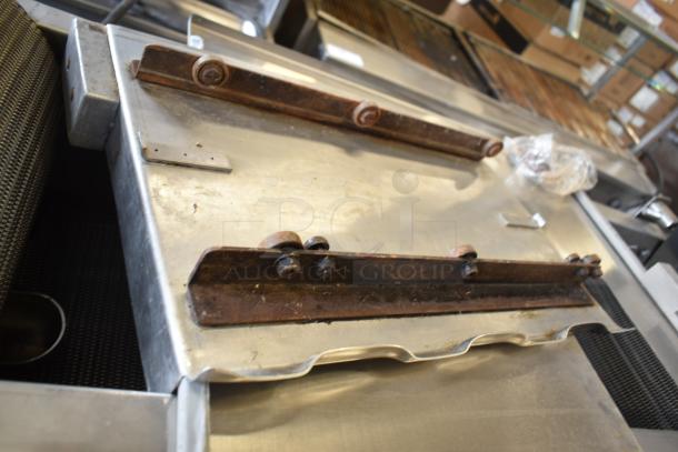 Lenin commercial gas chip fryer with conveyor on casters, 220,000 BTU. Metal finish, some rust on components, used condition.