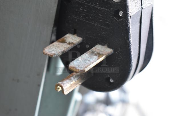 Plug of Lenin gas-powered chip fryer conveyor machine showing wear; part of the commercial kitchen equipment.