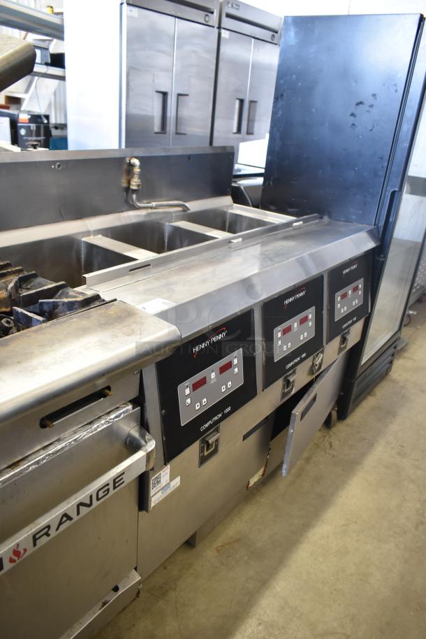Henny Penny OFG-323 commercial gas 3-bay deep fryer on casters, features digital controls and stainless steel construction.
