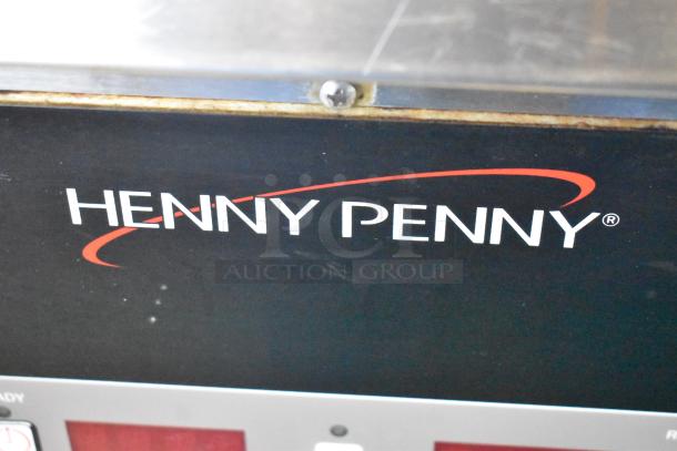Henny Penny OFG-323 fryer, commercial natural gas, 3-bay, on casters, shows brand logo on black surface.