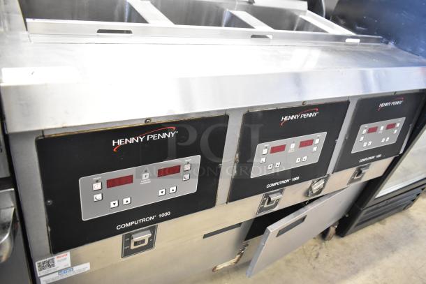 Henny Penny OFG-323 commercial 3-bay deep fat fryer, natural gas-powered, on casters, with digital controls.