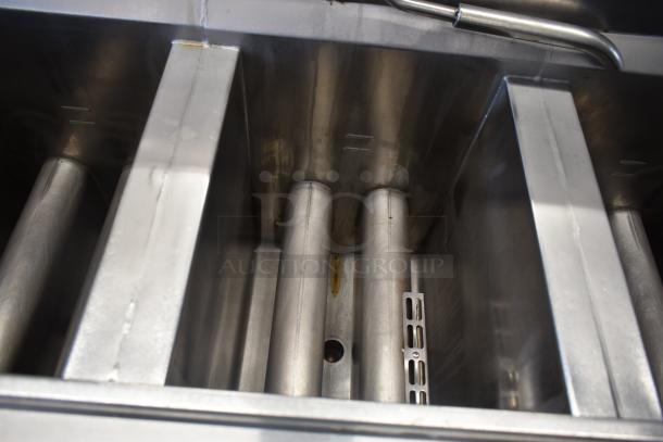 Henny Penny OFG-323 3 Bay Deep Fat Fryer, stainless steel interior, natural gas, commercial casters, used condition.