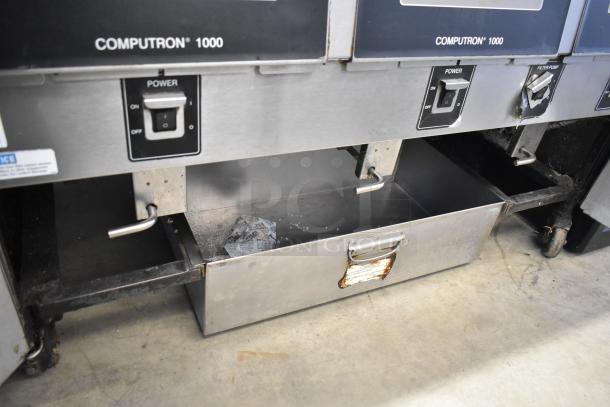 Henny Penny OFG-323 natural gas powered 3 bay deep fat fryer with Computron 1000 control, mounted on commercial casters.