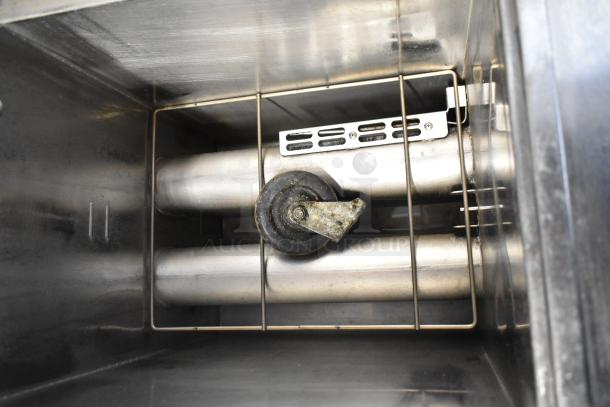 2019 Henny Penny OFG-322 natural gas fryer interior with heating elements and wheel, showing commercial use condition.