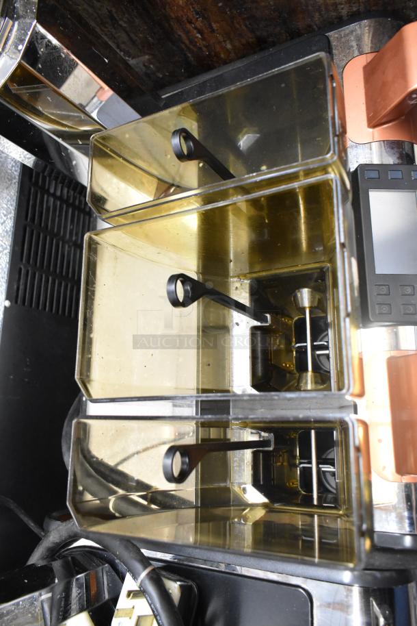 Thermoplan Mastrena II CS espresso machine with stainless steel body and steam wand, showing internal compartments.