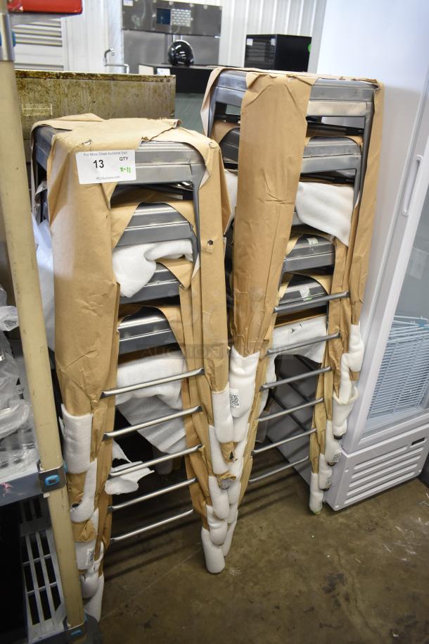 11 brand new Lancaster barstools, scratch and dent, alloy silver, backless, indoor use. Stacked and partially wrapped.