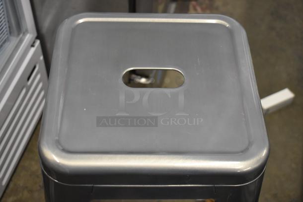 Brand new Lancaster Table & Seating alloy silver backless barstool, scratch and dent. Durable metal, industrial design.