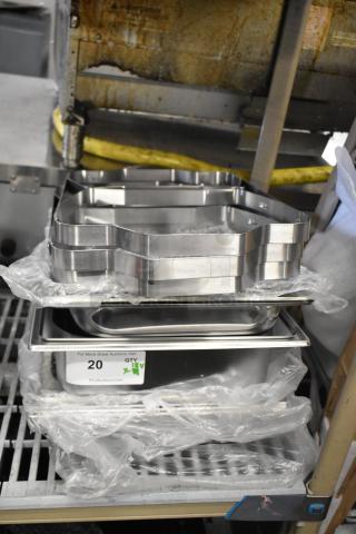 18 brand new scratch and dent items, including chafing dish frames and drop-in bins, with visible auction labels.