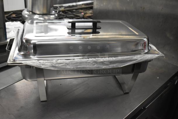 Brand new chafing dish with lid on stainless steel frame. Scratch and dent condition. Includes 18 items in lot.