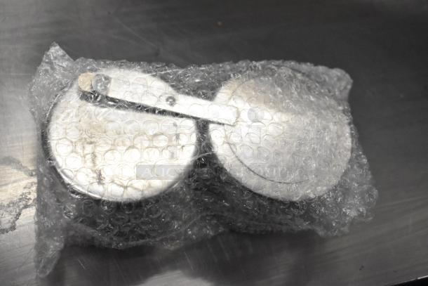 Bubble-wrapped items, possibly chafing dish lids, new condition with minor scratches, part of 18-item auction lot.