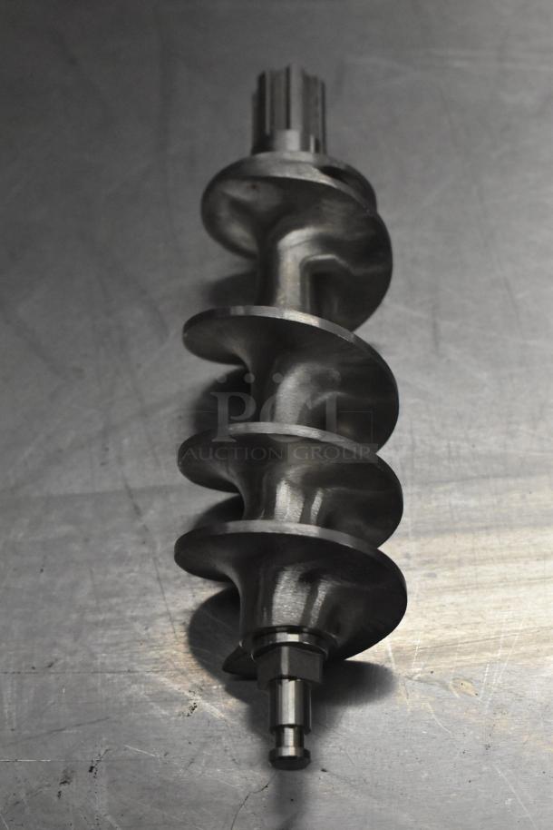 Metal auger screw on a metallic surface, showing new condition, part of a scratch and dent auction lot.