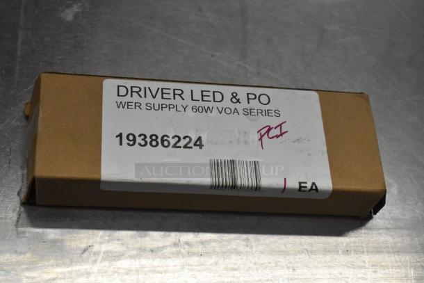 Box labeled "Driver LED & PO, WER Supply 60W VOA Series, 19386224," containing auction items.