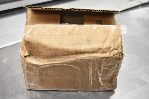 Damaged cardboard box containing five brand new scratch and dent items, including ballast, AC contactor, and hinge.