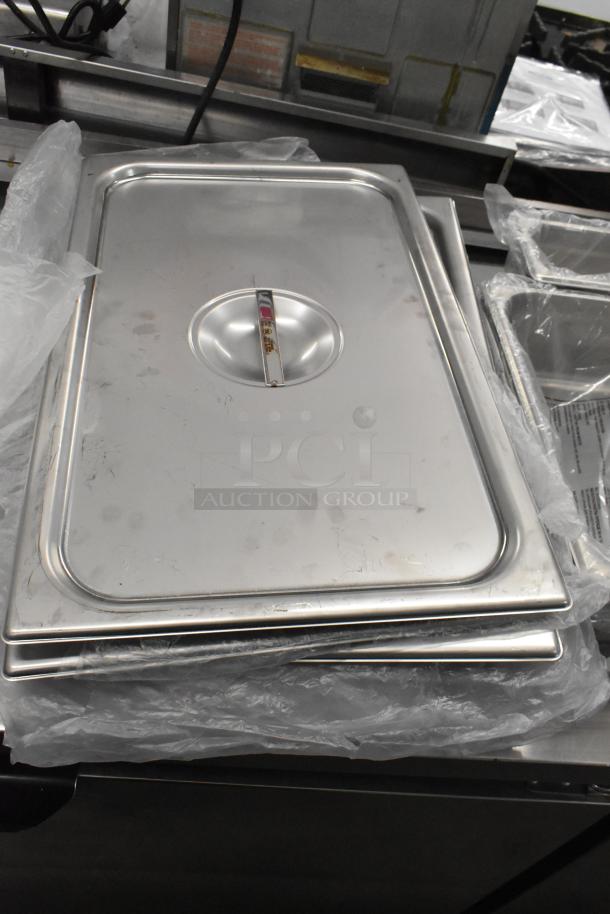 Brand new stainless steel lids with slight scratches, in original packaging. Part of a 14-piece scratch and dent auction set.