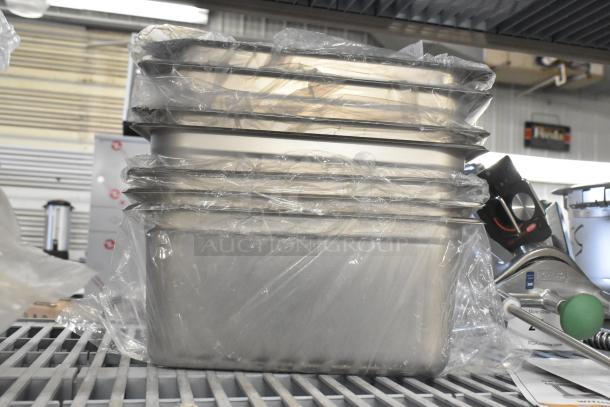 21 new scratch and dent drop-in bins, stacked, wrapped in plastic. Durable material, ideal for storage or organization.