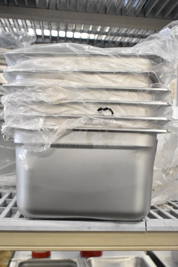 Stack of 21 brand new drop-in bins in original packaging, minor scratches and dents visible, suitable for bulk purchase.