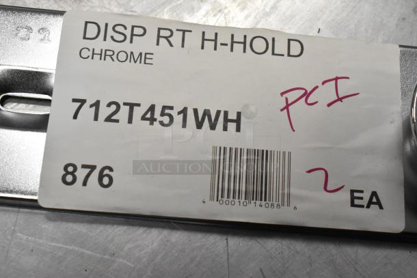 Label on a chrome part reading "DISP RT H-HOLD," model "712T451WH," marked "PCI," with barcode and "2 EA."