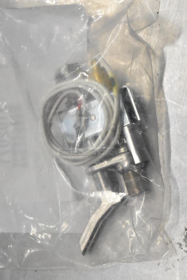 Bag of assorted new items including a door switch and cable, possibly scratch or dented. Contents are sealed in plastic.