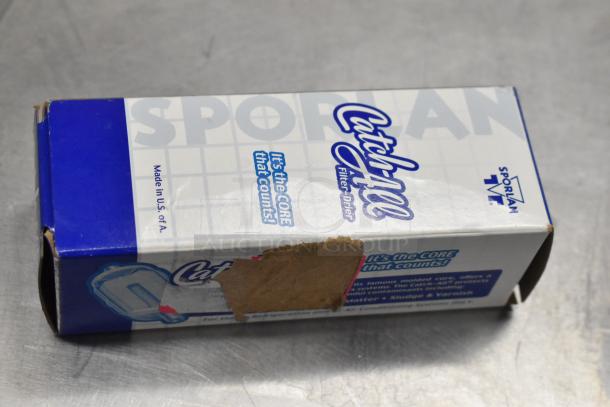 Box of Sporlan Catch-All filter-drier, partially sealed, marked "Made in U.S.A." with wear on cardboard.