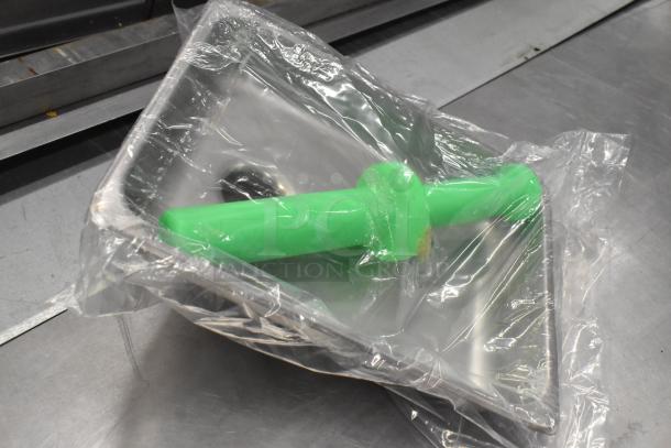 Brand new meat grinder attachment with green pusher, auger, and tray, in packaging. Scratch and dent condition.