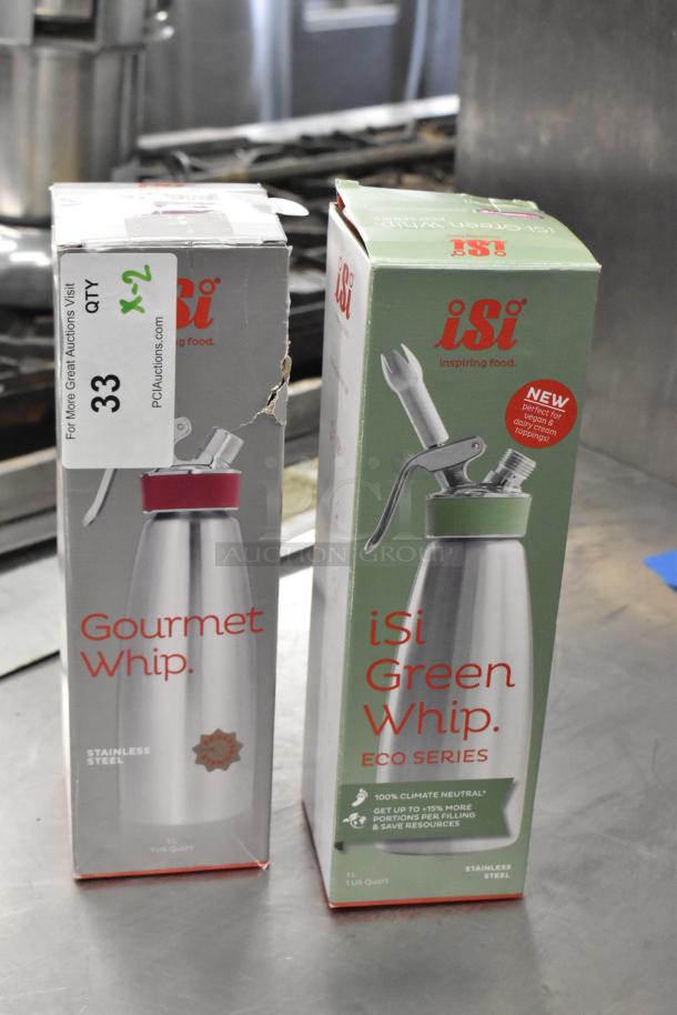 Two iSi 1L whipped cream dispensers: Gourmet Whip and Green Eco Series, brand new, in original packaging, with slight box damage.