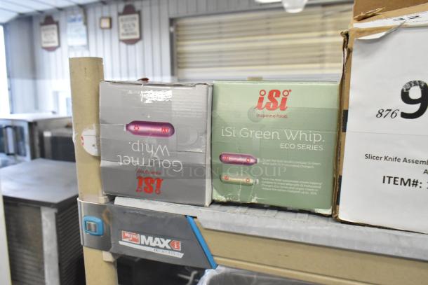 Two new iSi 1L cream dispensers: Gourmet Whip 170301 and Eco Series Green 176101, visible in original boxes.