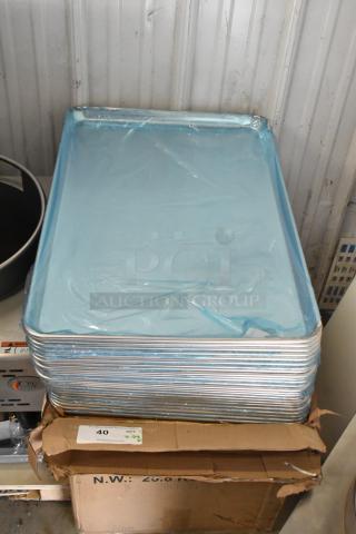 29 brand new scratch and dent aluminum bun pans, size 18" x 26", 19 gauge, stacked with protective blue wrap.