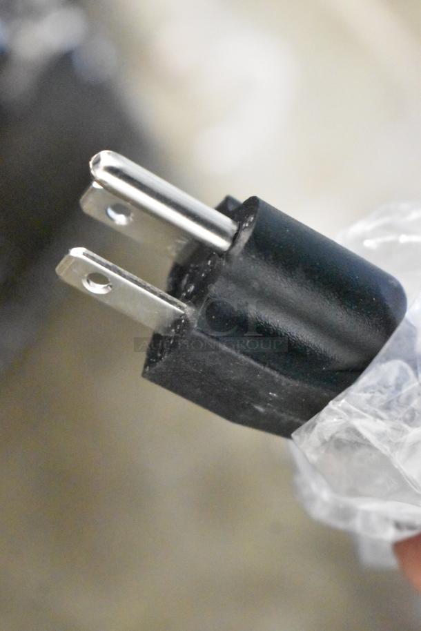 Close-up of a power plug for the KoolMore CDC-3C-WH Countertop Display Refrigerator, showing two-prong connector.